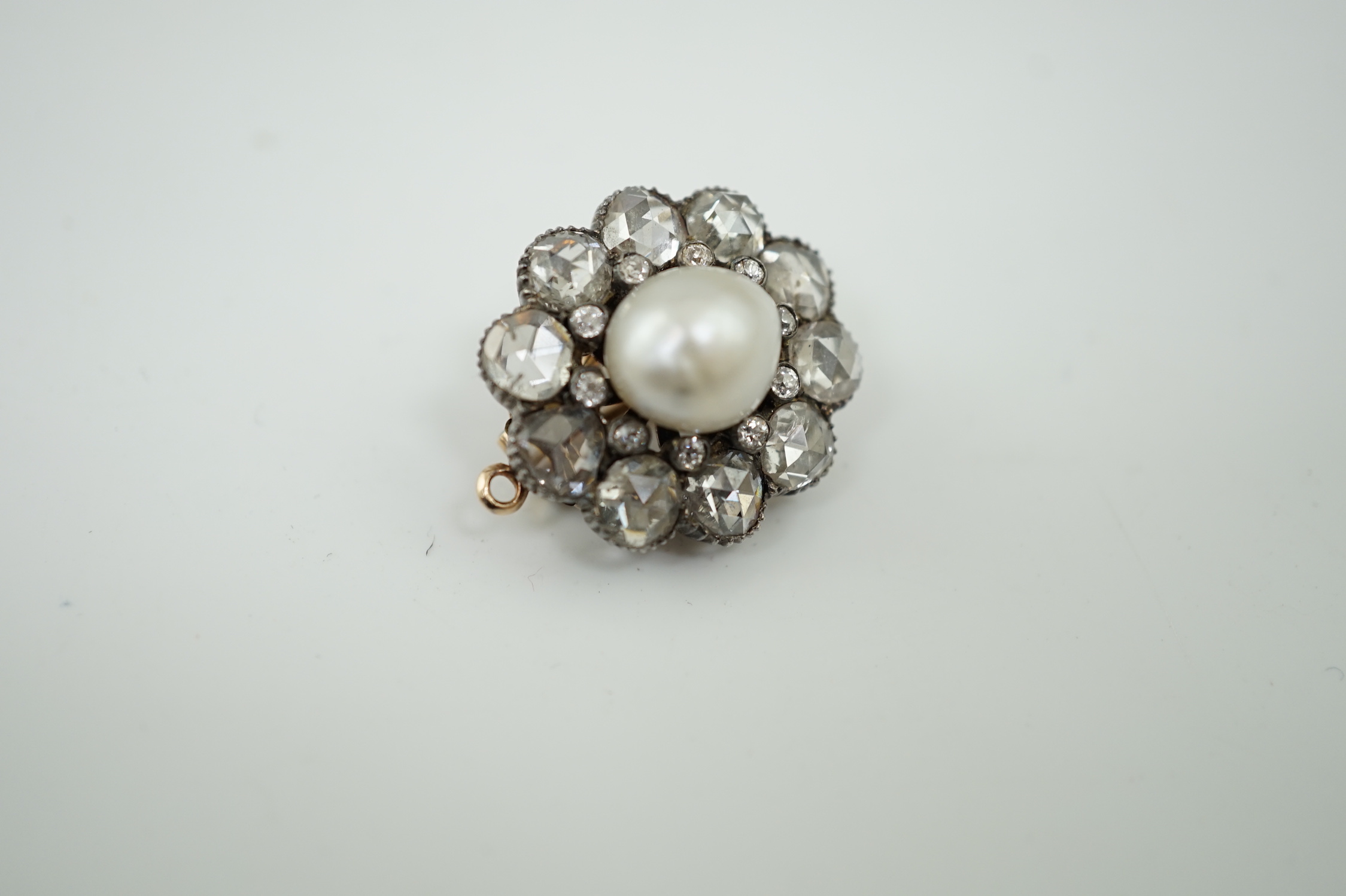 A 19th century gold and silver, single stone natural saltwater part drilled button pearl and rose and round cut diamond cluster set pendant brooch